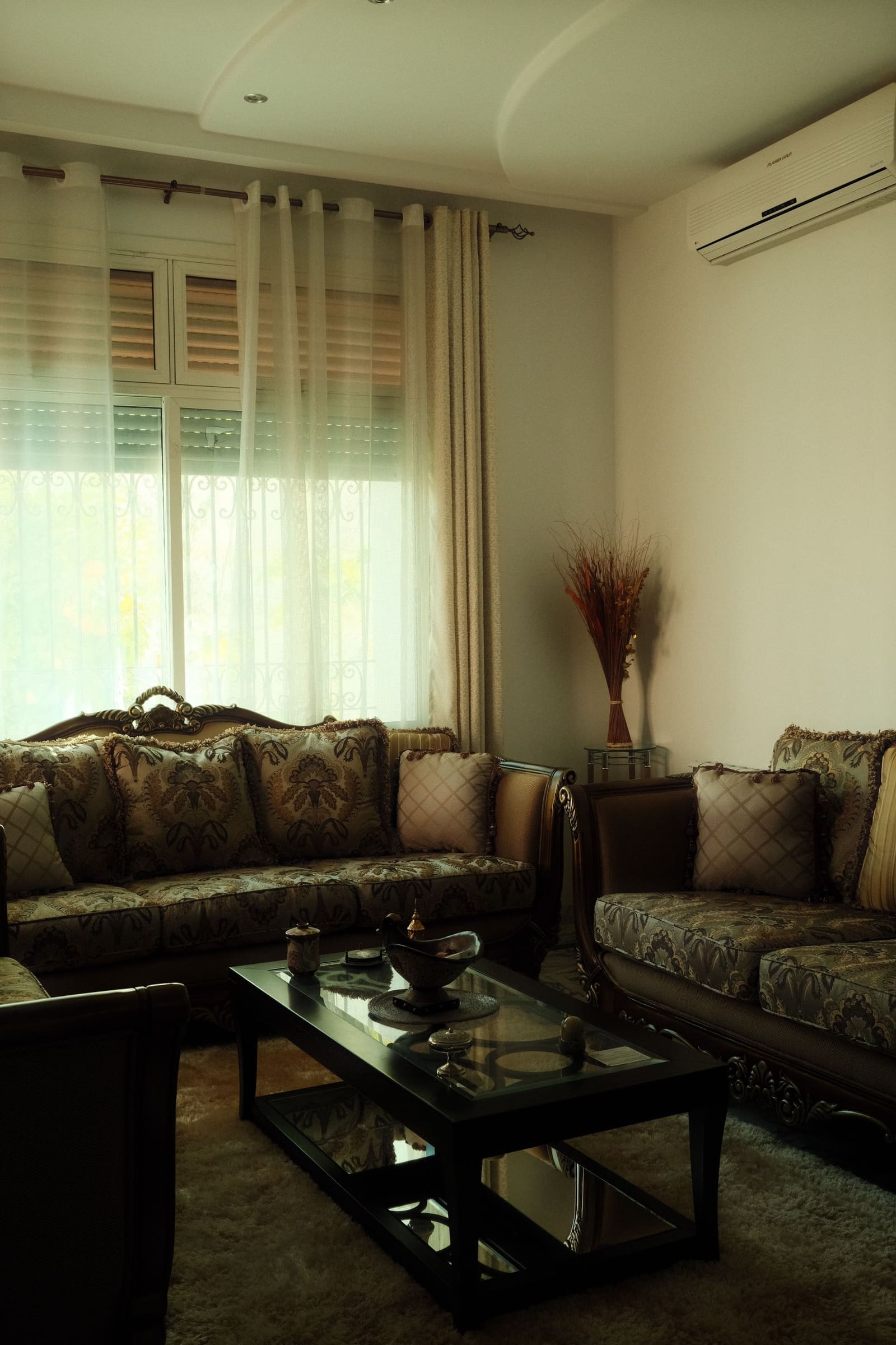 Compact living room with storage bench in an Aundh 2BHK apartment